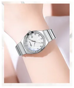 Detailed view of silver ladies quartz watch with rhinestone bezel and calendar on wrist