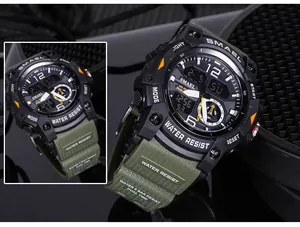 Detailed macro view of SMAEL rugged outdoor watch featuring dual display and green strap.