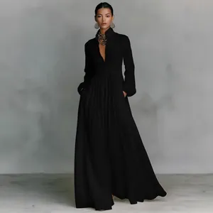 Full-length view of elegant black pleated maxi dress with long sleeves and pockets