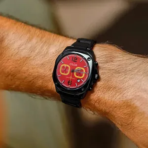 Men's sports watch with red dial and black stainless steel band close-up
