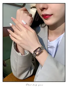 Elegant luxury ladies watch with chocolate rectangular dial and two-tone strap worn by model