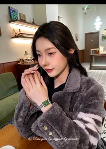Elegant women's fashion watch featuring square emerald green dial and silver metal link bracelet