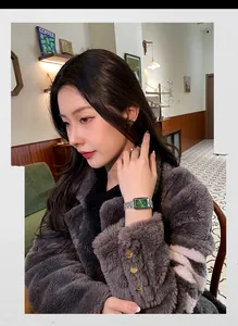 Elegant women's watch with green dial and silver band worn by a model in a cafe.