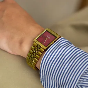 Détail de la montre carrée vintage CILOA avec bracelet doré et cadran rouge texturé