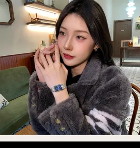 Elegant CILOA rectangular women's watch with blue dial and silver band on wrist.