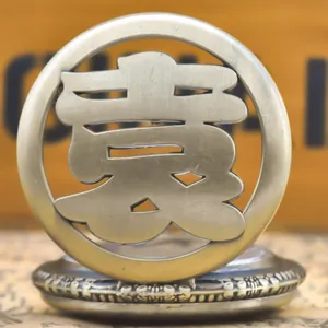 Macro view of vintage bronze pocket watch featuring hollowed-out Chinese family name Yuan