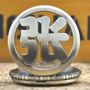 Close-up of vintage pocket watch featuring hollowed Chinese character "Zhang"