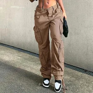 Macro view of women's brown cargo pants featuring multiple utility pockets and street style