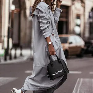 Detailed side view of a stylish light grey mid-length trench coat with large lapels.