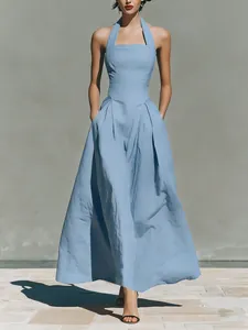 Elegant light blue halter maxi dress with pockets featuring a slim fit linen-like fabric