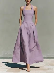 Full-length view of a lavender halter neck linen-like maxi dress with side pockets