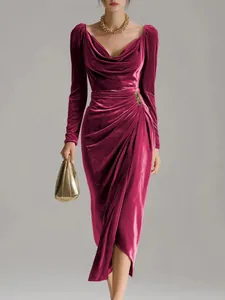 Detailed view of an elegant ruched velvet dress with a stylish split hem design