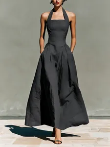 Detail shot of a dark grey linen-like halter neck maxi dress with elegant side pockets