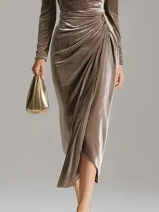 Detailed view of ruched velvet maxi dress featuring an elegant high slit design