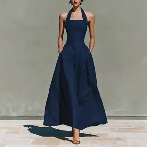 Elegant navy blue halter neck maxi dress with pockets for a chic summer fashion look.