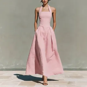 Elegant pink halter-neck maxi dress with pockets and linen-like texture for summer