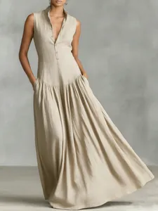 Detail view of French style sleeveless V-neck maxi dress with pleated skirt in beige