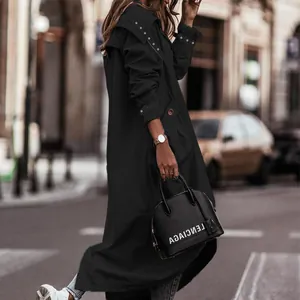 Side view of a long black trench coat with large lapels and shoulder eyelets