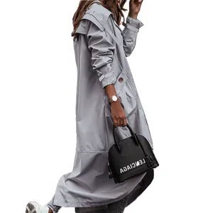 Detail view of light grey long trench coat with oversized lapel for women