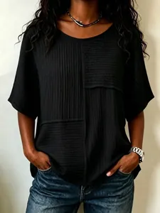Casual women's black T-shirt featuring a unique wrinkled fabric patchwork design and mid sleeves.