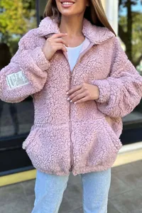 Close-up of a cozy pink sherpa fleece zip-up jacket featuring a decorative sleeve patch