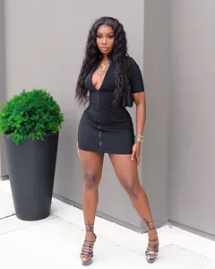 Model wearing a sexy black bodycon mini dress with a front zipper detail outdoors