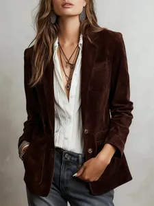 Detailed view of an elegant brown suede jacket with pockets and button closure for women