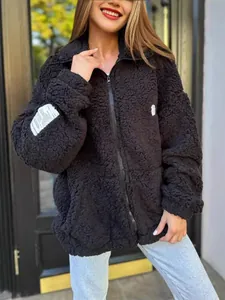 Cozy women's black sherpa fleece zip-up jacket with decorative patches for winter outdoor