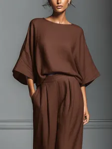 Elegant brown linen two-piece set featuring flared sleeves and wide-leg trousers