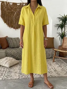 Casual yellow linen short sleeve polo collar dress for women in a lifestyle setting