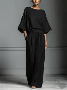 Elegant black linen two-piece set featuring flare sleeves and flowing wide-leg trousers