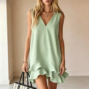 Close-up of light green V-neck sleeveless dress with ruffle hem detail