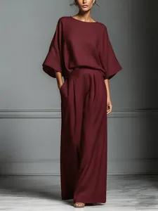 Elegant burgundy linen two-piece set featuring flare sleeves and wide-leg trousers.