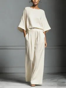 Elegant off-white linen two-piece set featuring bell sleeve top and wide leg trousers