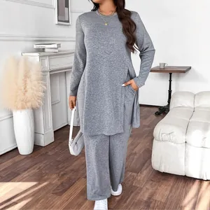 Full-length view of a grey two-piece set with a long tunic and wide-leg trousers.
