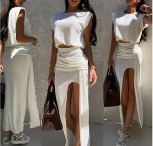 White sleeveless crop top and high slit maxi skirt two-piece set with draped detail