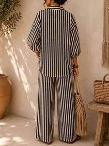 Stylish back view of a black and white vertical striped shirt and wide-leg pants set