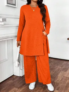 Vibrant orange two-piece casual set featuring long-sleeve side-slit top and wide-leg pants