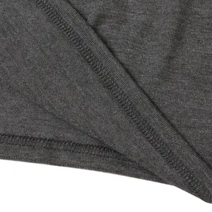 Macro view of high-quality overlock stitching on dark grey kangaroo t-shirt hem.
