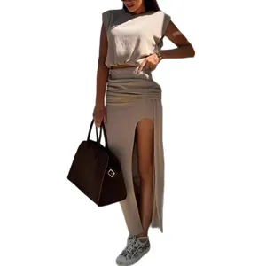 Elegant beige two-piece set featuring sleeveless round neck top and high slit skirt