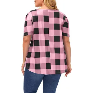 Back view of a women's plus size short sleeve pink and black buffalo plaid tunic top