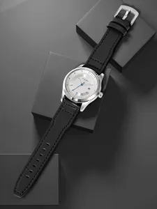 Elegante Detailansicht der TOMI minimalistischen Lederarmbanduhr auf grauen Blöcken