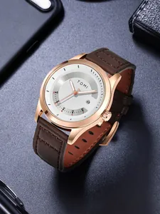Detailaufnahme der minimalistischen TOMI-Lederuhr mit rotgoldenem Gehäuse und Datum