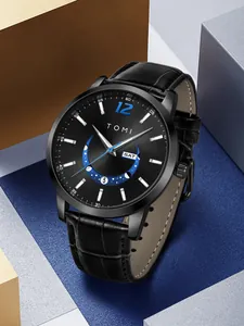 Close-up detail of TOMI minimalist black dial watch with leather strap and calendar