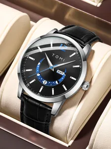 Close-up detail of TOMI fashion watch with black leather strap and blue calendar dial