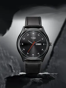 Detail view of TOMI minimalist black watch with leather strap and day-date display