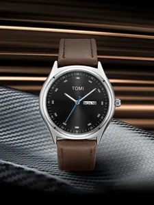 Detailed macro view of TOMI minimalist fashion watch with black dial and brown leather strap
