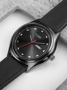 Close-up macro view of the watch dial with day-date window and red second hand detail