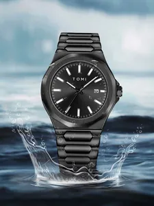 Close-up view of the TOMI black steel business watch emerging from a dynamic water splash