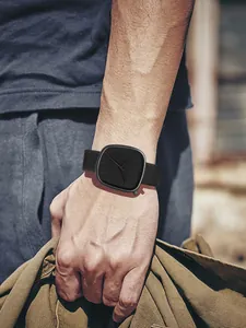 Vue détaillée d'une montre à quartz carrée noire minimaliste portée sur un poignet
